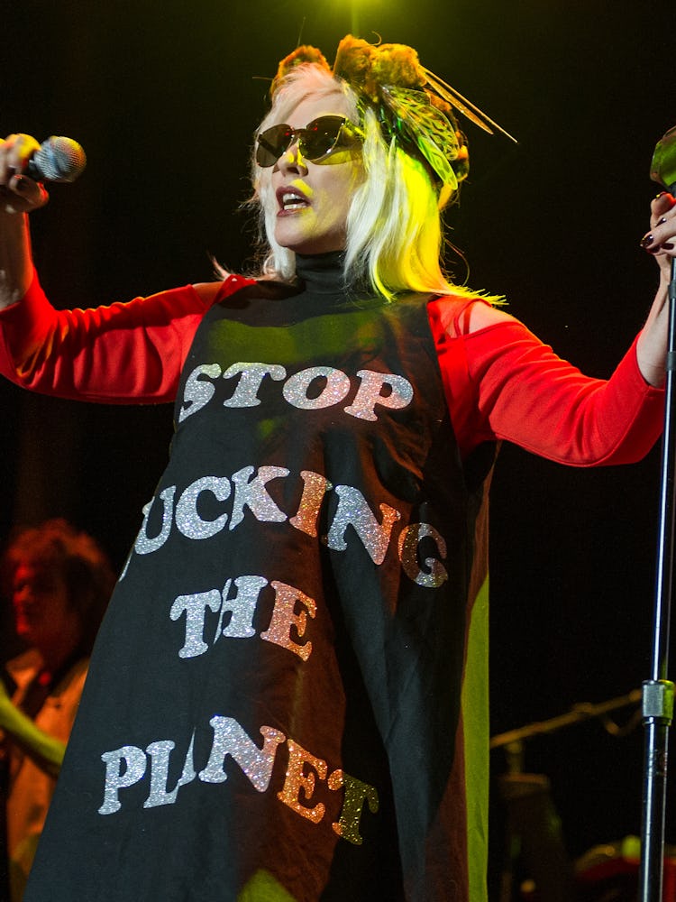 Debbie Harry in a black-red dress with the text 'STOP FUCKING THE PLANET'