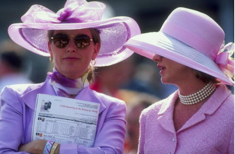 Two women in a purple in a pink dress and matching hats at the Kentucky Derby in 1998.
