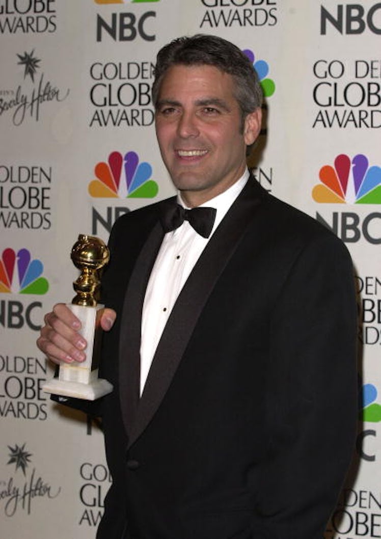 George holding a Golden Globe