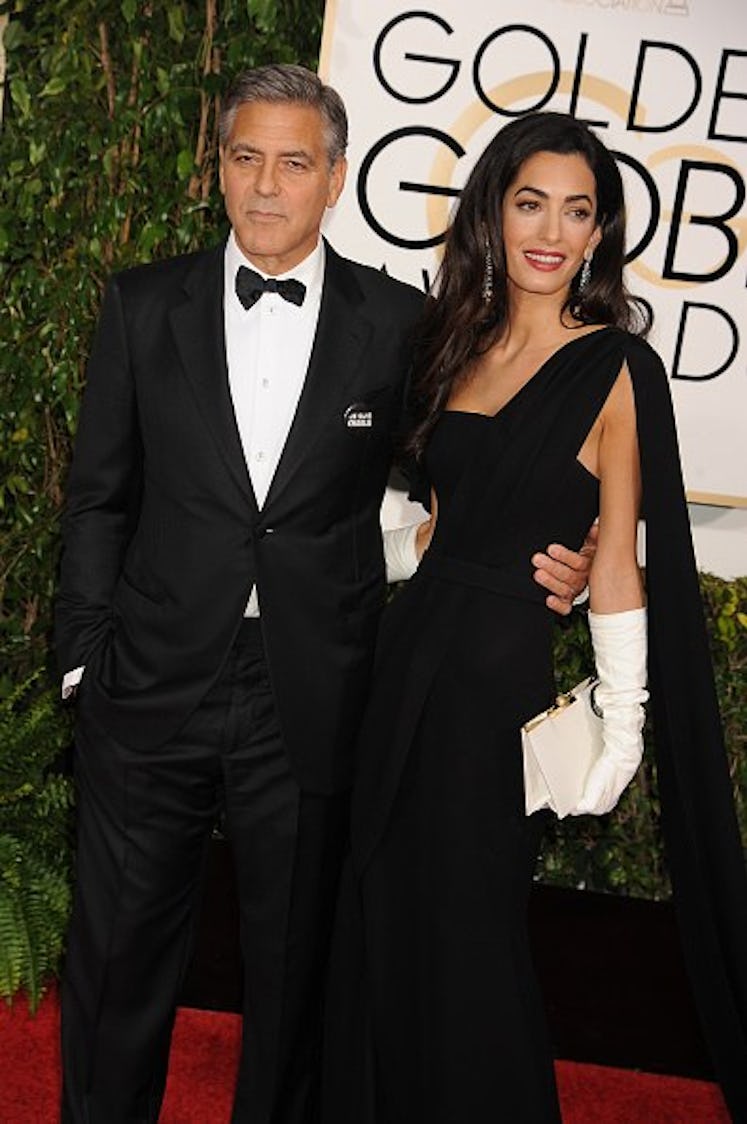 George in a black tux, Amal in a black gown and white gloves
