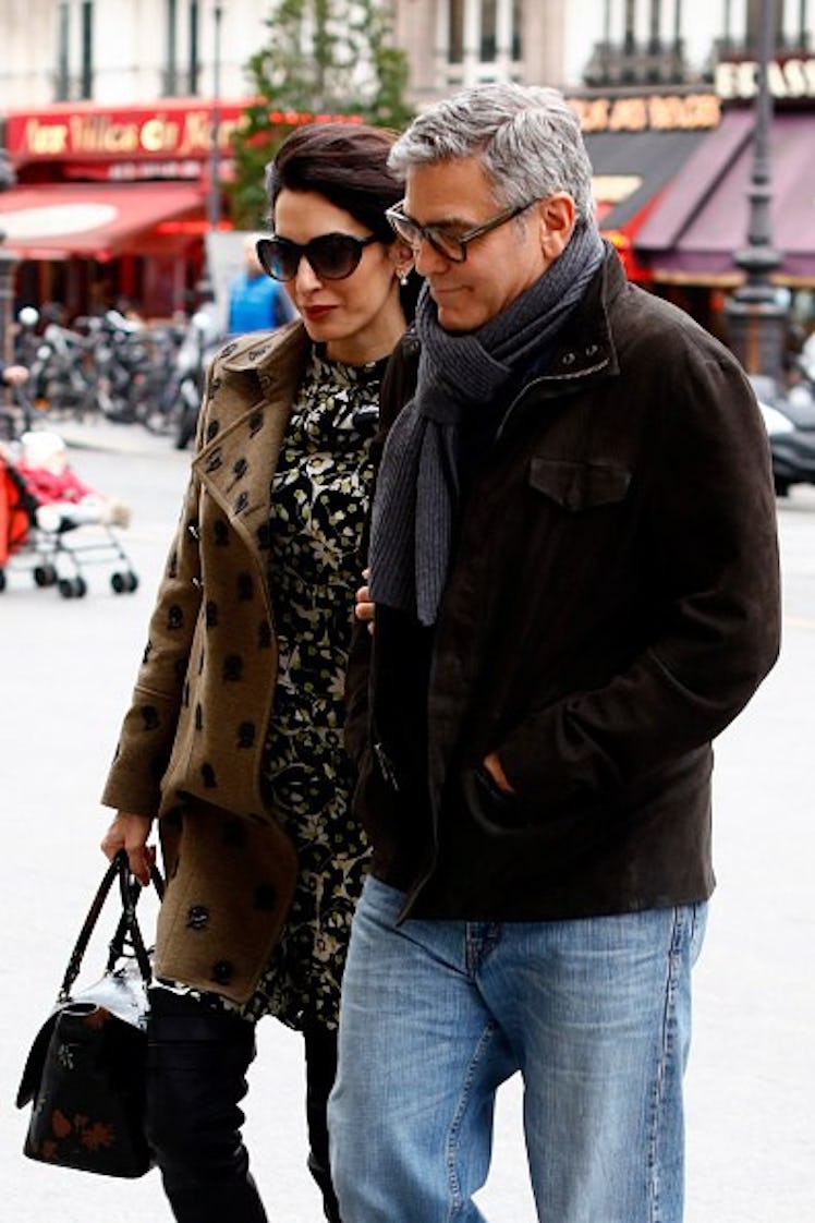 George in a cozy scarf next to Amal