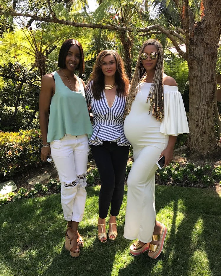 Tina Lawson, one of the savviest celebrity moms on social media, posing with Beyonce and Kelly Rowla...