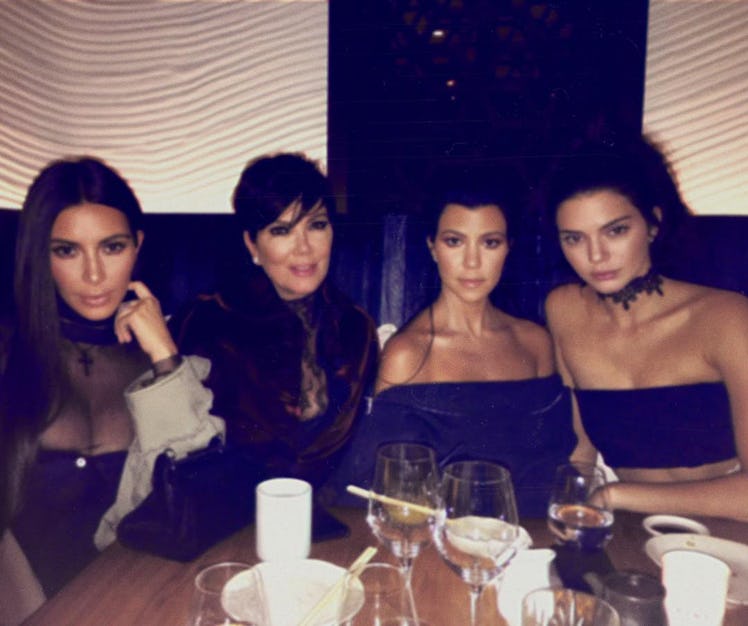 Kim Kardashian, Kris Jenner, Kourtney Kardashian and Kendall Jenner sitting in a restaurant