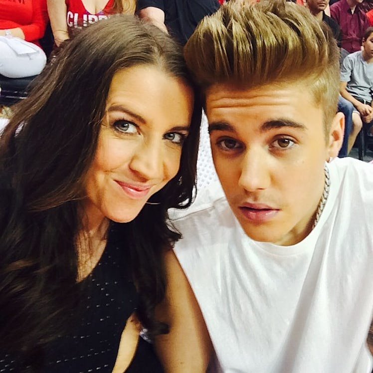 Pattie Mallette in a black shirt and Justin Bieber in a white shirt taking a selfie together