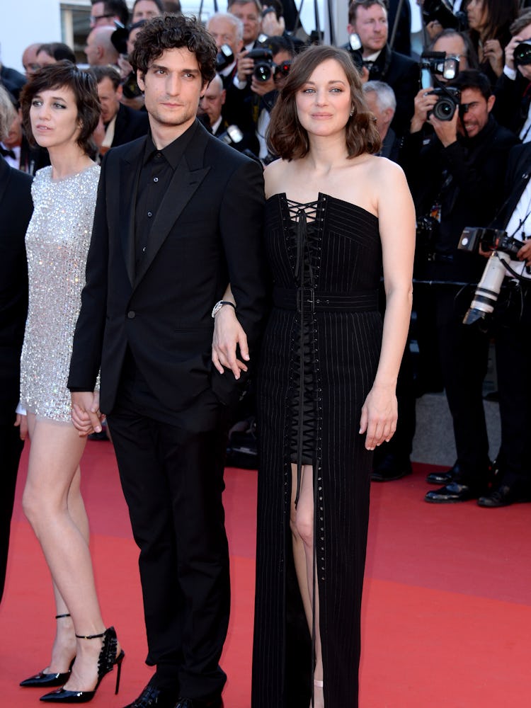Louis Garrel in a black suit and Marion Cotillard in a black dress Jessica Chastain in a black dress...