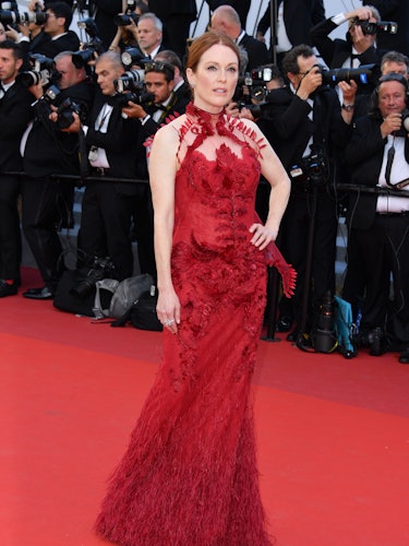 Julianne Moore in a red lace dress at the premiere of Ismael’s Ghosts opening the Cannes Film Festiv...
