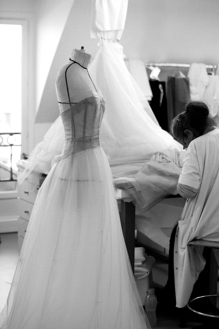 A seamstress working on Elle Fanning’s Cannes gown