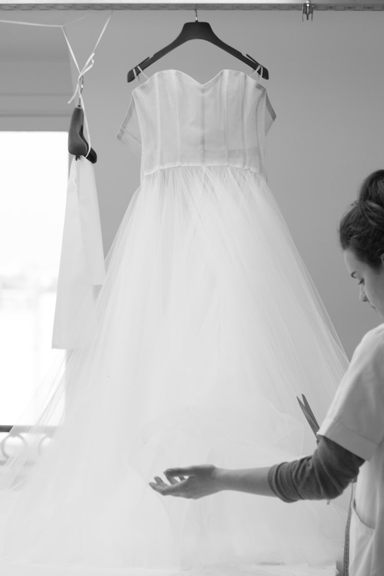 A seamstress working on Elle Fanning’s Cannes gown