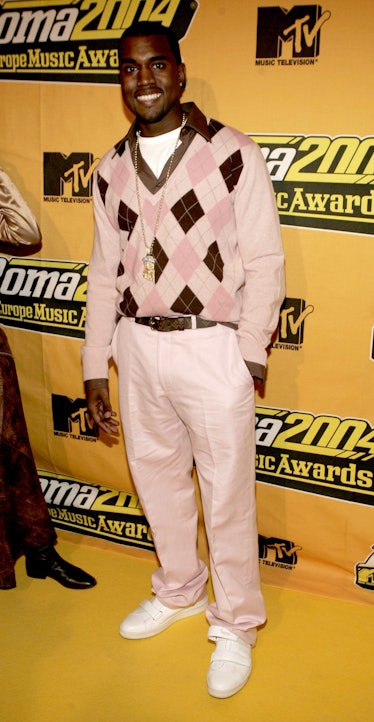 Kanye West in a pink argyle sweater and pants and gold jewelry at the 2004 European Music Awards