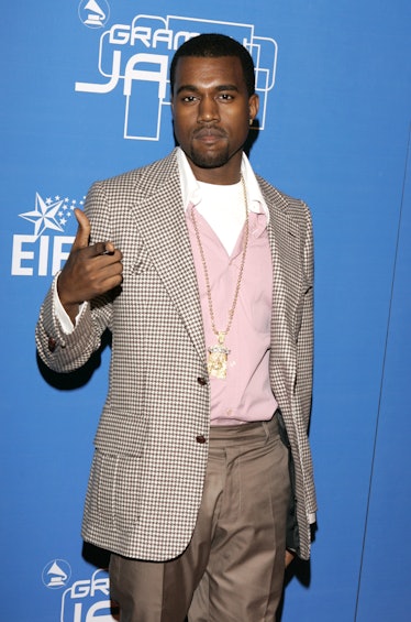 Kanye West in a a light brown suit over a pink sweater at an event in 2004