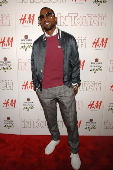 Kanye West in a grey bomber jacket, red crew neck sweater and grey pants at the In Touch 5th Anniver...