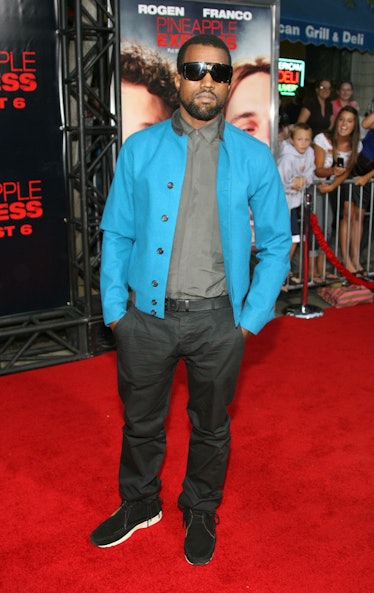 Kanye West in a grey shirt, blue jacket and grey pants at a red carpet event in 2008