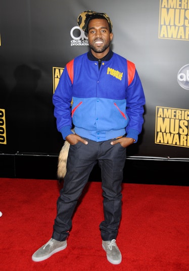 Kanye West in a blue bomber jacket, printed hat, and jeans at the 2008 American Music Awards