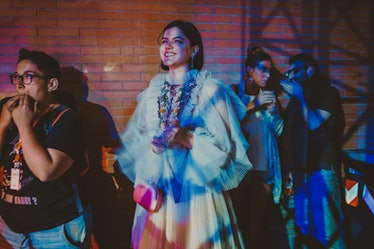 Soko, smiling while attending a performance by the band Whitney