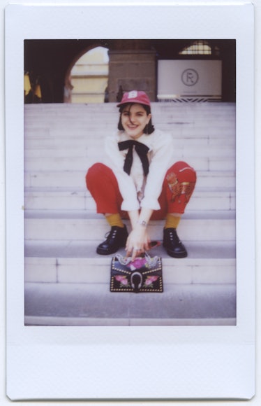 Soko smiling while sitting on the stairs in Bologna.