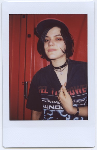 Soko wearing a band tee, a red hat and a set of choker necklaces during her trip to Italy