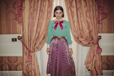 Soko wearing a colorful pleated skirt paired with a mint green shirt with a pink bow in Italy