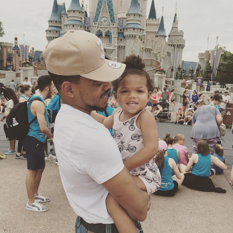 An Instagram post with Chance the Rapper holding his daughter in a Disneyland Park