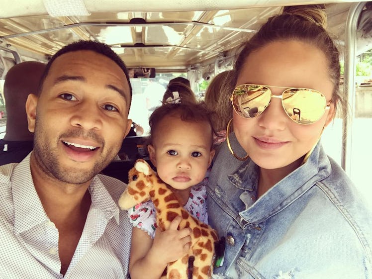 An Instagram selfie post with John Legend and Chrissy Teigen posing with their daughter between them