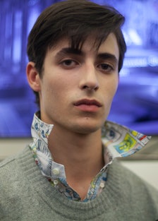 A model in a patterned shirt and a grey sweater at Milan for Spring 2018