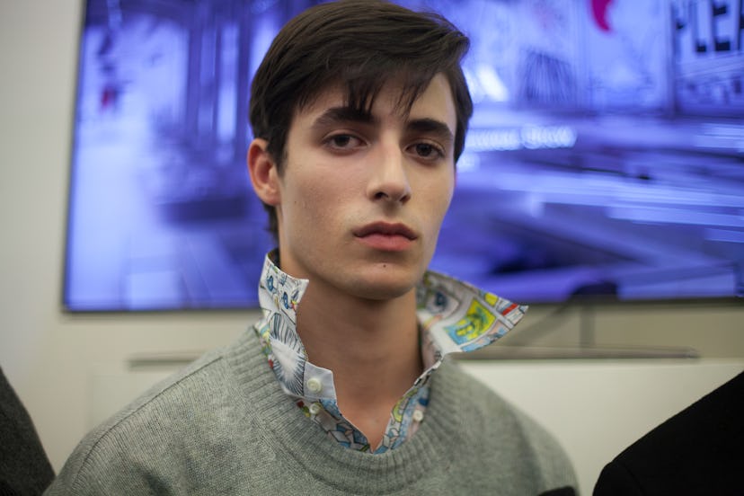 A model in a patterned shirt and a grey sweater at Milan for Spring 2018