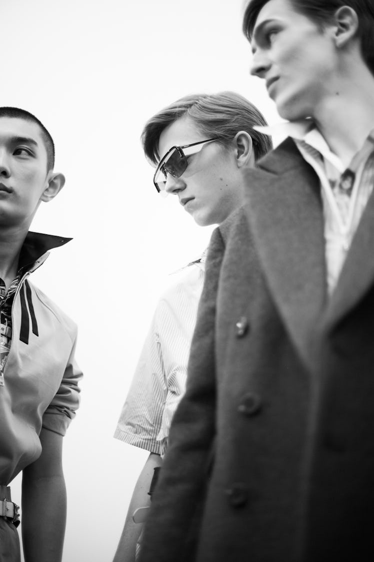 Three models standing backstage at the Prada Spring/Summer 2017 show