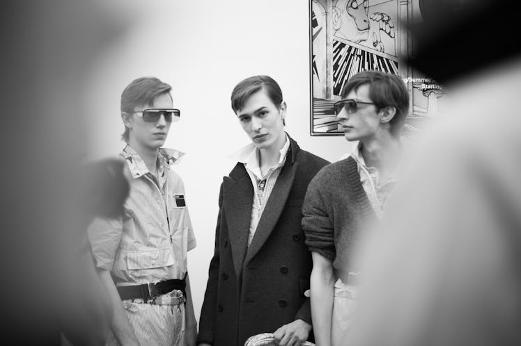 Three models standing and posing backstage at the Prada Spring/Summer 2017 show