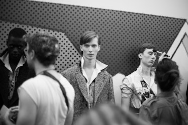 A group of models getting ready backstage at the Prada Spring/Summer 2017 show