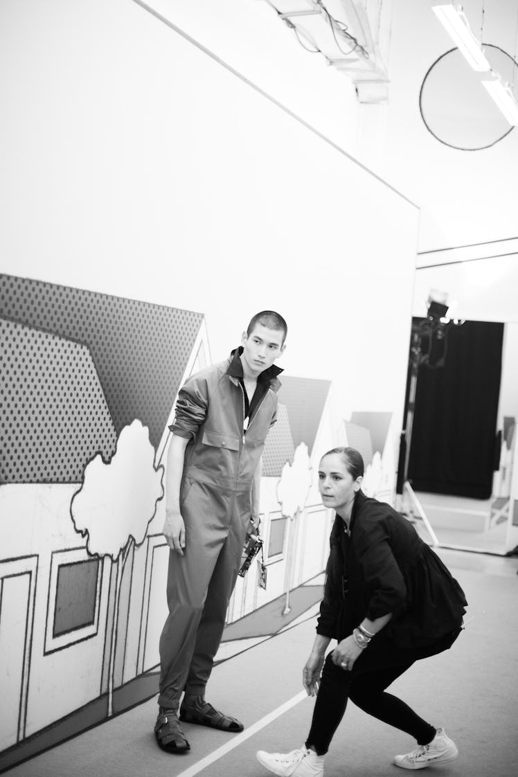 A model posing and a woman standing next to him at the Prada Spring/Summer 2017 show