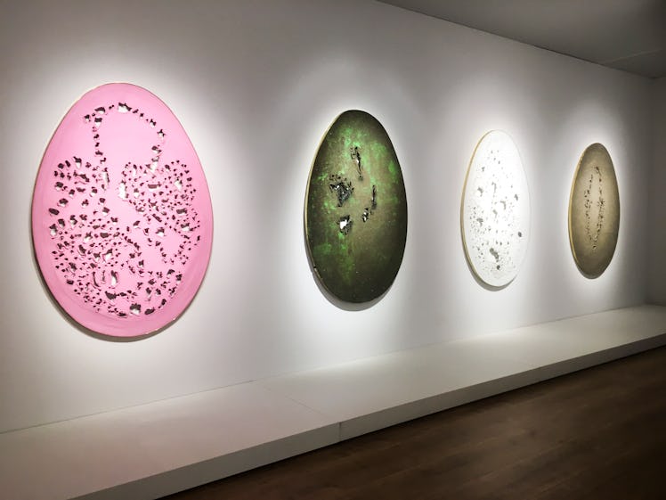 FOUR Lucio Fontana egg paintings on a wall