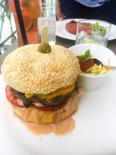 A picturesque cheeseburger served with a salad