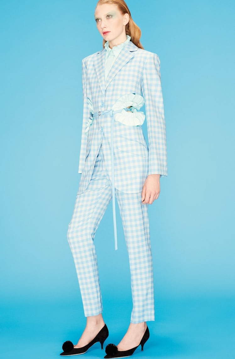 A female model posing in a white classic printed formal suit