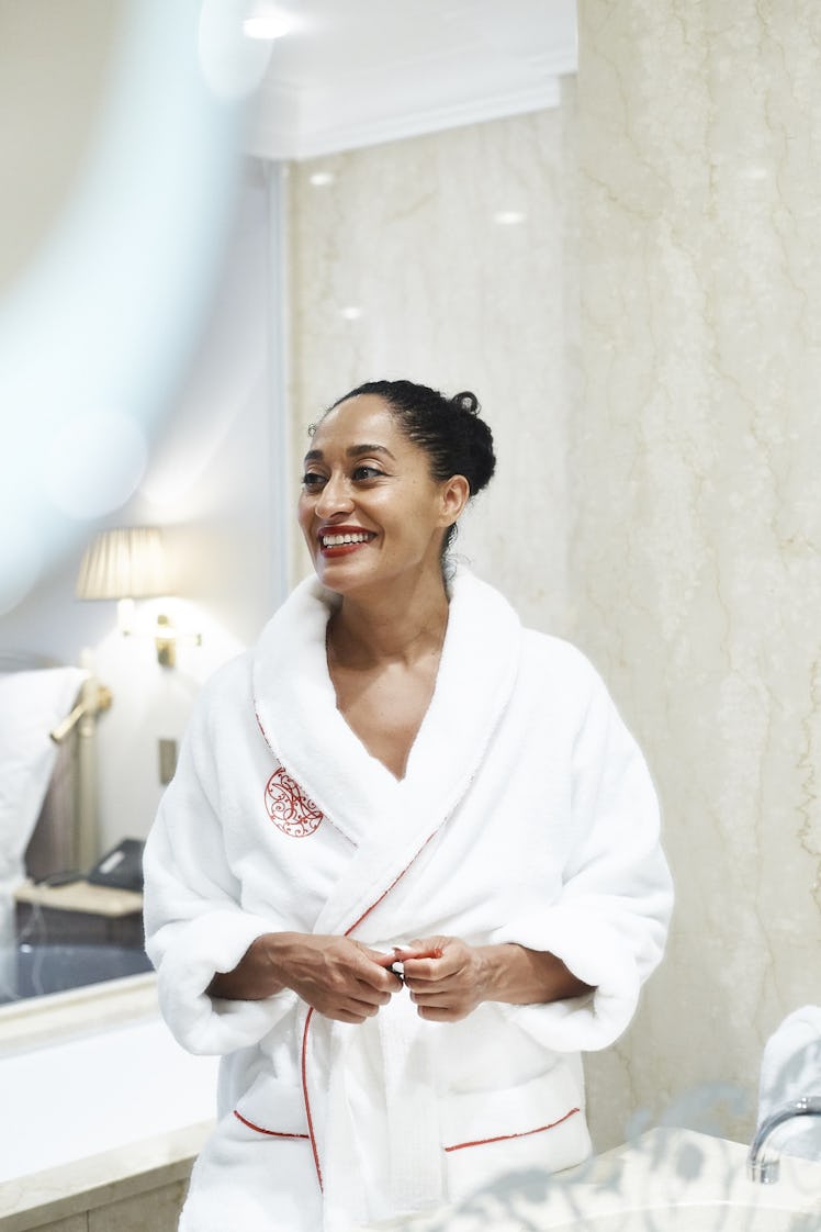 Tracee Ellis Ross smiling in a bath robe 