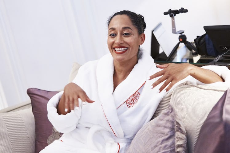 Tracee Ellis Ross in a bath robe smiling while talking 