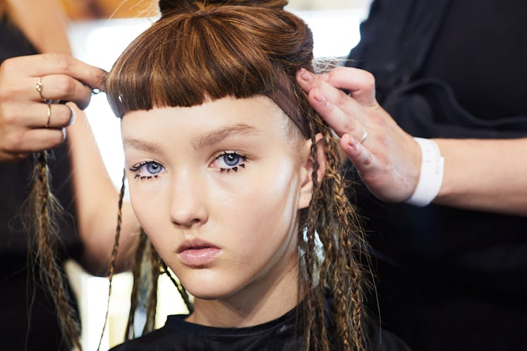 A model getting her hair done backstage at Iris Van Herpen's 10th Anniversary Fashion Show