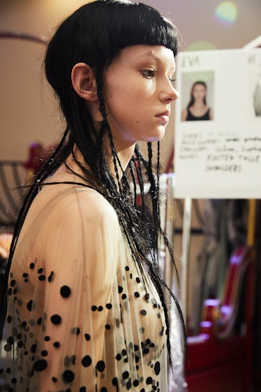 A model in a white-black tulle dress with sequins backstage at Iris Van Herpen's 10th Anniversary Fa...