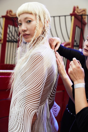 A model getting ready backstage at Iris Van Herpen's 10th Anniversary Fashion Show