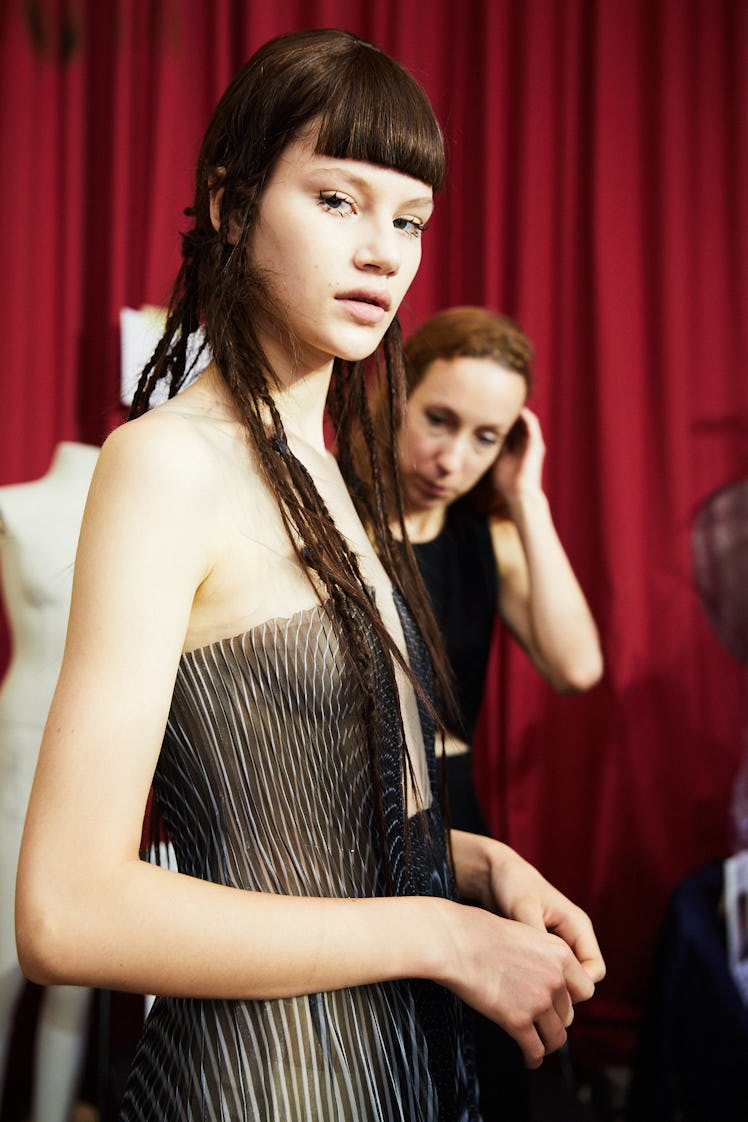 A model in a black tulle dress backstage at Iris Van Herpen's 10th Anniversary Fashion Show
