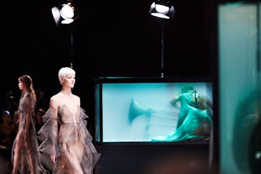 Two models walking on the runway at the Iris Van Herpen's 10th Anniversary fashion show