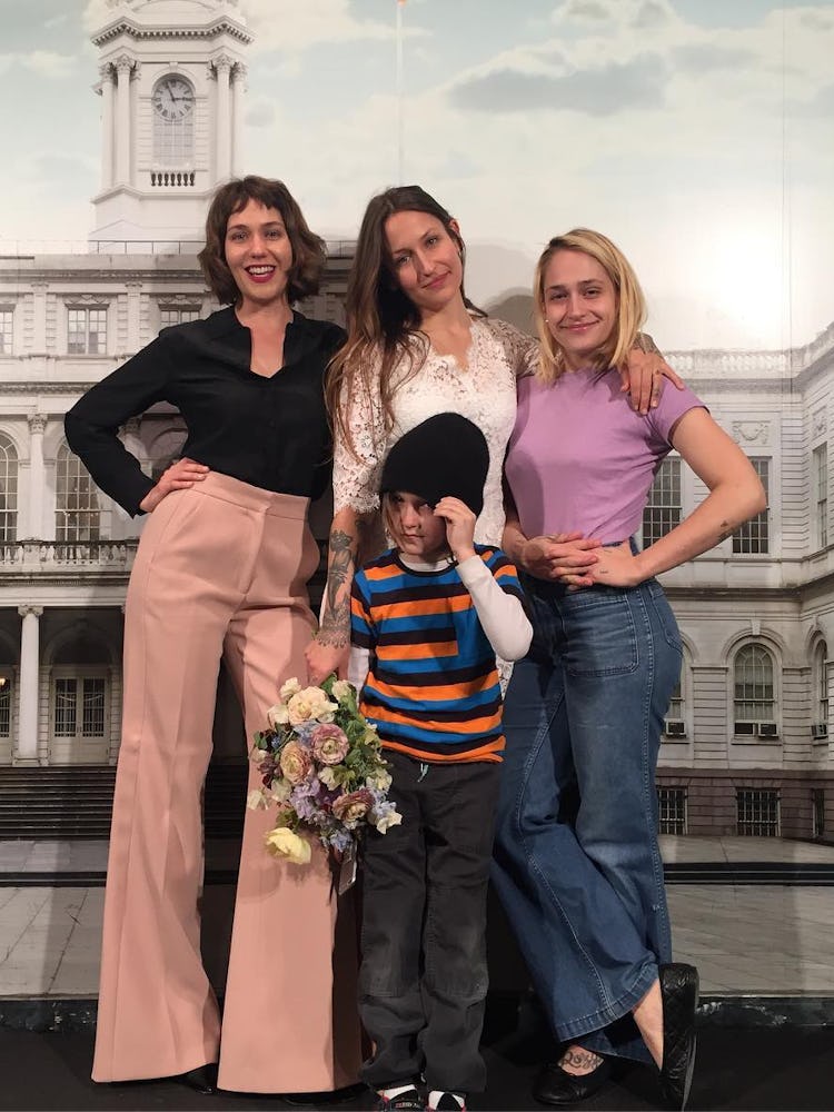 Domino Kirke poses with sisters Jemima and Lola at her civil ceremony wedding to Penn Badgely 