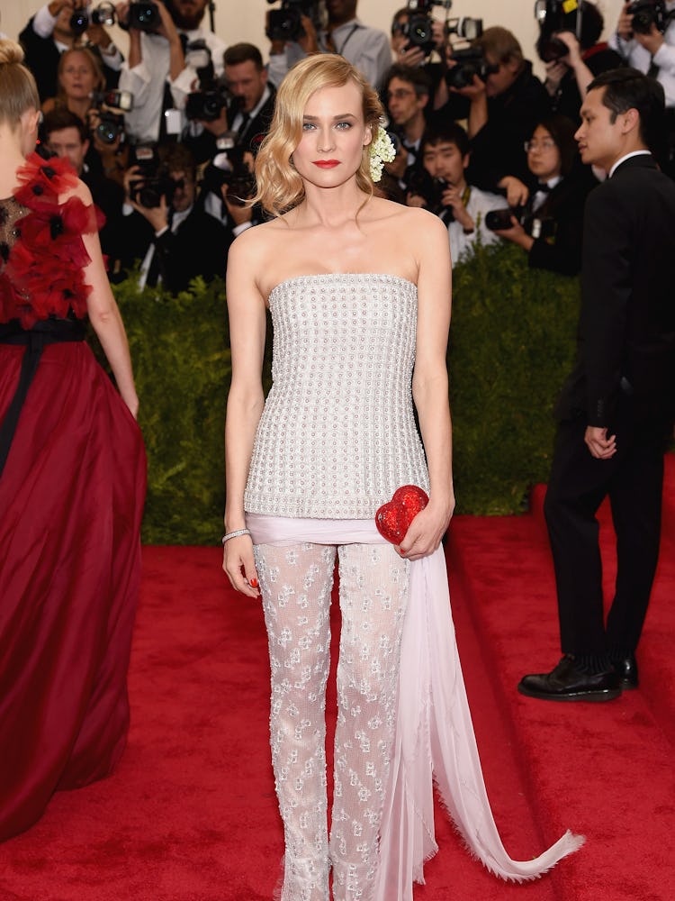 Diane Kruger in a grey top and white lace trousers at the Met gala “China: Through The Looking Glass...
