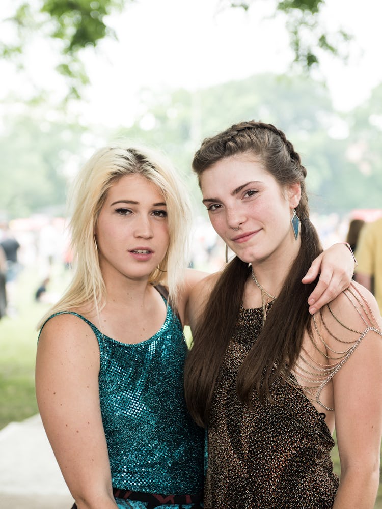 A woman in a teal sequin and a woman in a brown top posing at the Pitchfork Music Festival