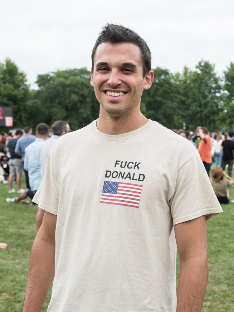 A man in a beige shirt with the American flag and text at the Pitchfork Music Festival