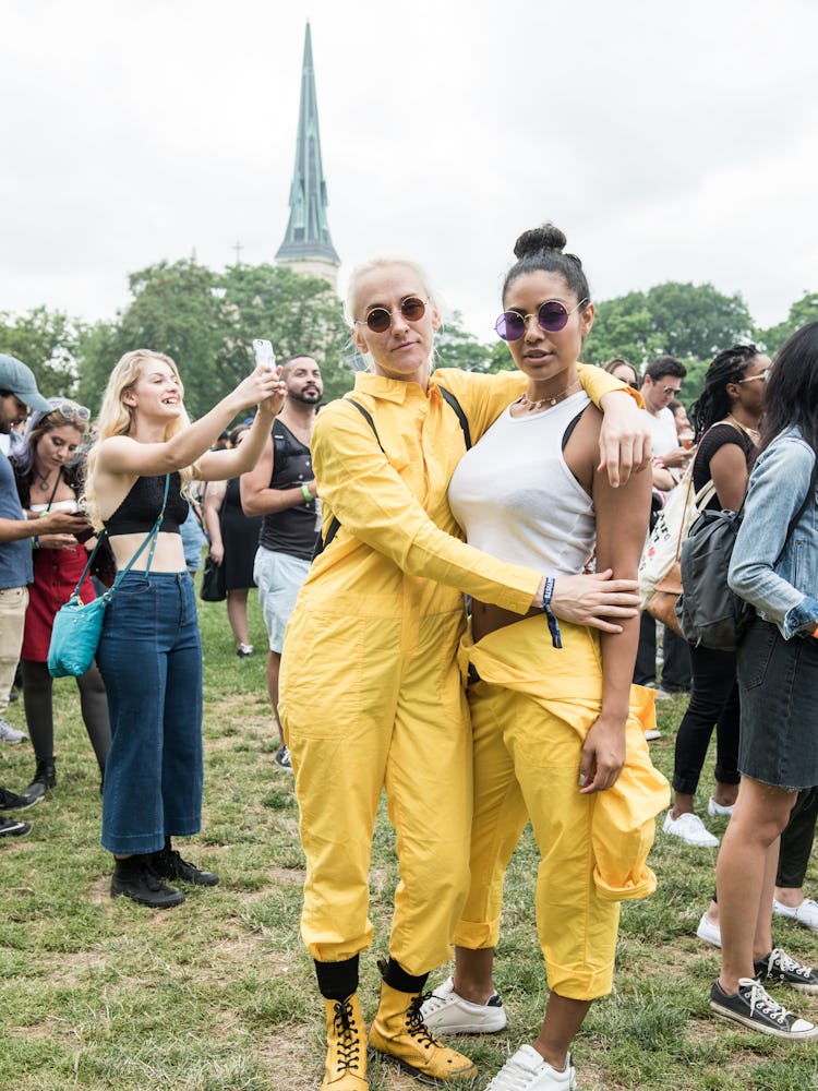 Two women in yellow jumpsuits at the Pitchfork Music Festival standing and posing