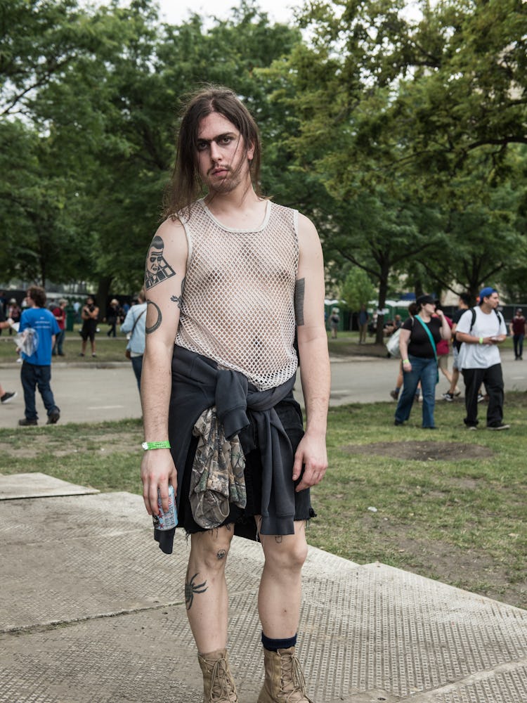 A man in a beige top and a grey sweater wrapped around his waist the Pitchfork Music Festival