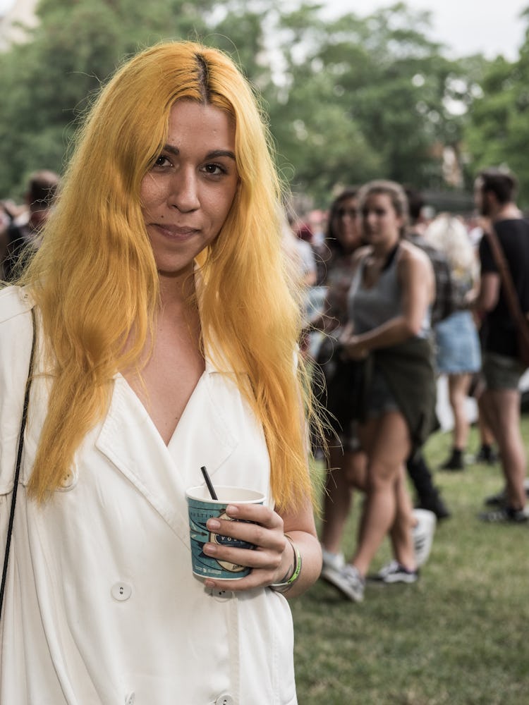 A woman with orange hair and a white waistcoat-dress at the Pitchfork Music Festival