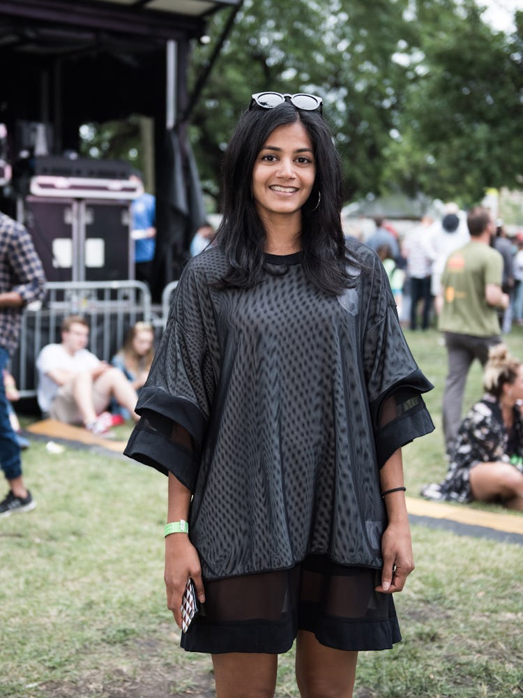 A woman in a black-white tulle dress smiling and posing at the Pitchfork Music Festival