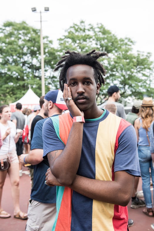 A man in a blue-orange-green-yellow striped shirt attending the Pitchfork Music Festival