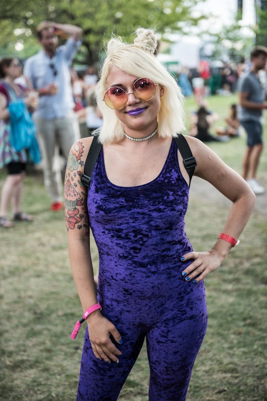 A woman in a velvet purple jumpsuit attending the Pitchfork Music Festival