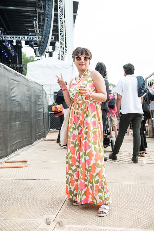 A woman in a pink-green-white floral dress attending the Pitchfork Music Festival